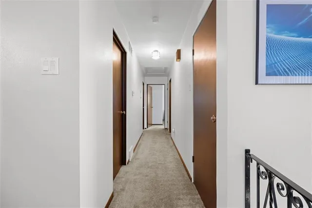 a view of an empty room with a fireplace and a window