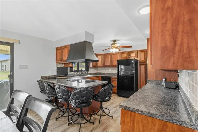 a kitchen with a table chairs and a refrigerator