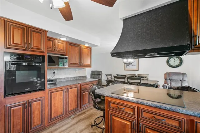 a kitchen with stainless steel appliances granite countertop a sink and a stove