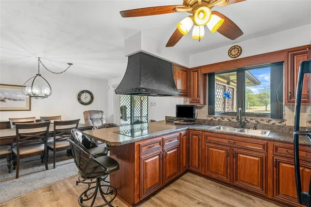 a kitchen with a sink a cabinets and chairs