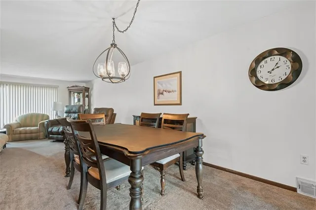 a view of a dining room with furniture and a chandelier