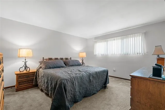 a bedroom with a bed and a night stand