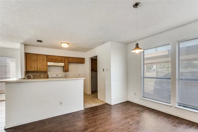 an empty room with wooden floor and sliding door