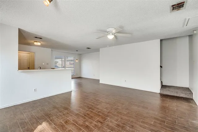 a view of a kitchen with wooden floor and a kitchen space