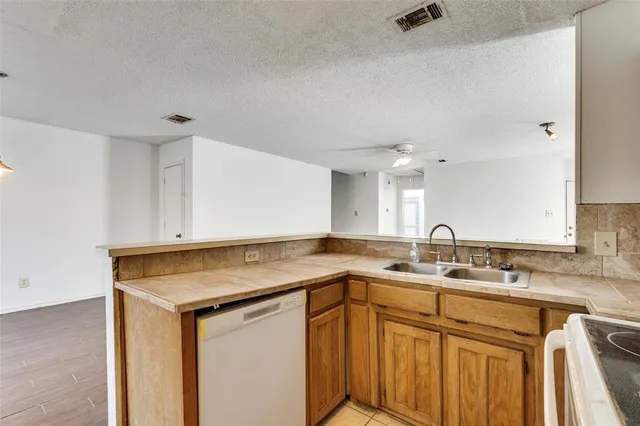 a kitchen with stainless steel appliances a stove a sink and a refrigerator