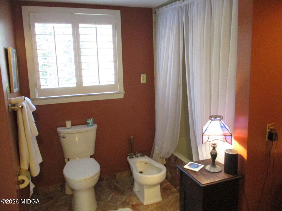 1121 South Jackson Springs Road Macon, GA 31211 - Photo 23 of 29 a bathroom with a toilet sink and mirror