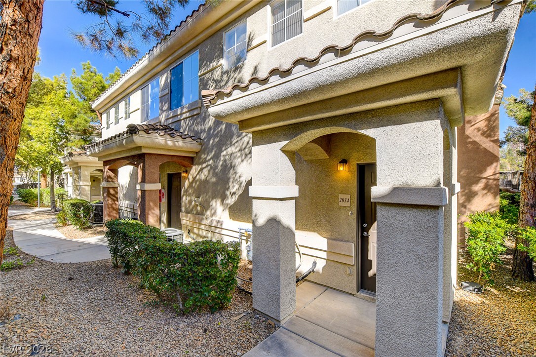 9050 West Warm Springs Road, Unit 1034 Las Vegas, NV 89148 - Photo 3 of 17 Welcome to a charming multi-level residence featuring a classic tile roof and well-maintained exterior finishes.