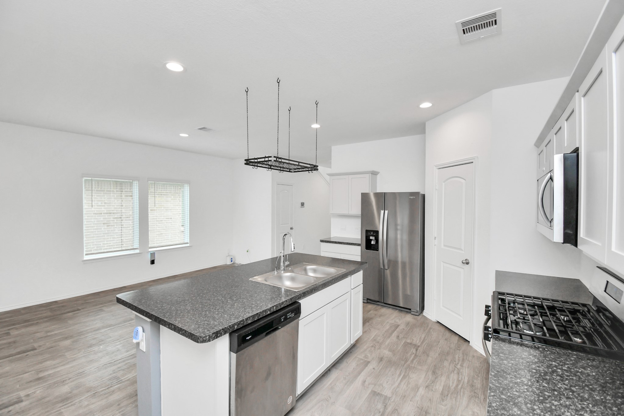 5443 Pinetree Crescent Ln Spring Spring, TX 77373 - Photo 11 of 43 a kitchen that has a sink a center island stainless steel appliances and cabinets