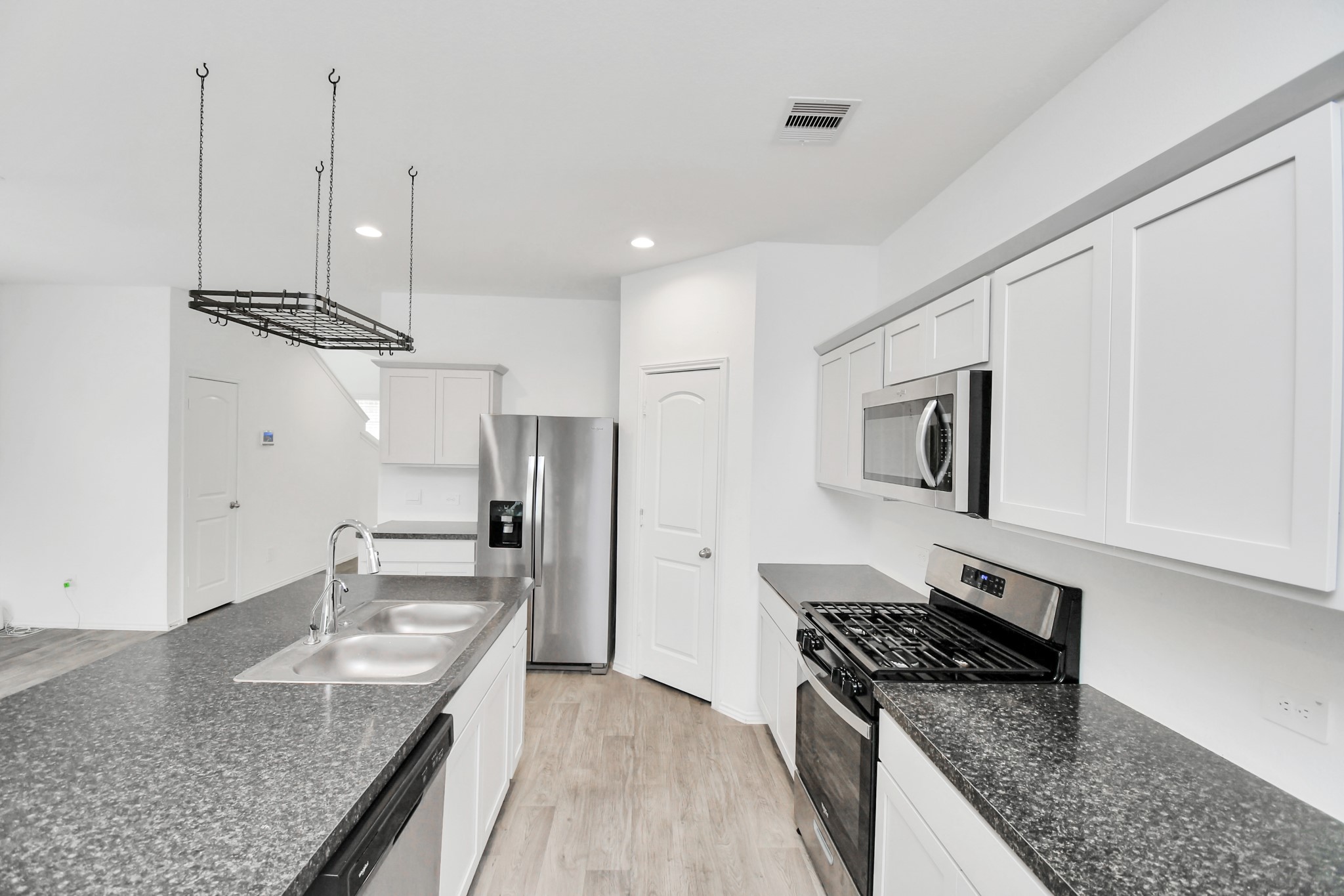 5443 Pinetree Crescent Ln Spring Spring, TX 77373 - Photo 12 of 43 a kitchen with granite countertop stainless steel appliances and wooden cabinets