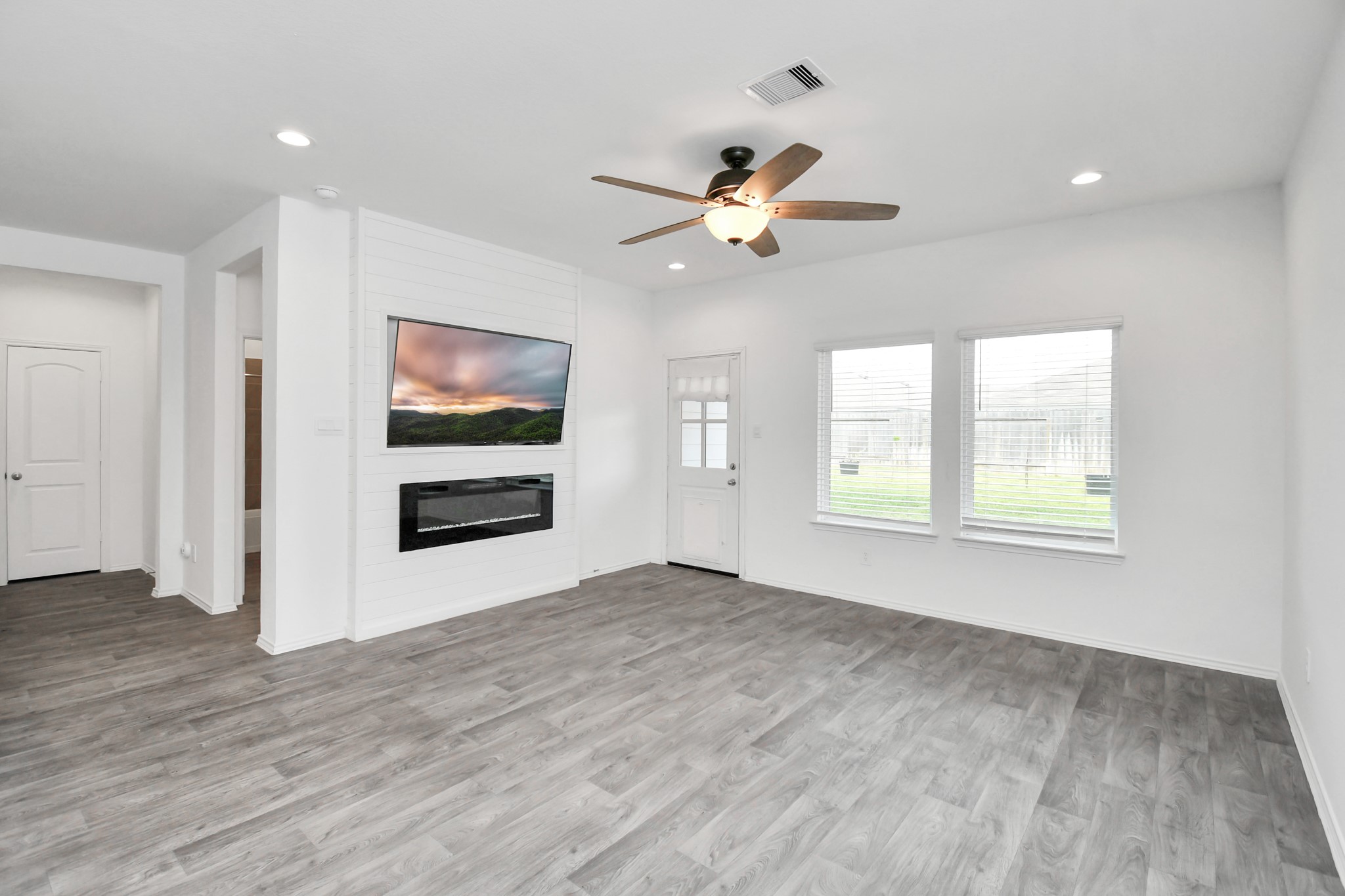 5443 Pinetree Crescent Ln Spring Spring, TX 77373 - Photo 14 of 43 a view of an empty room with a window and wooden floor