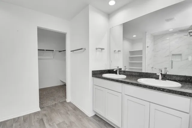 a bathroom with double sink and a mirror