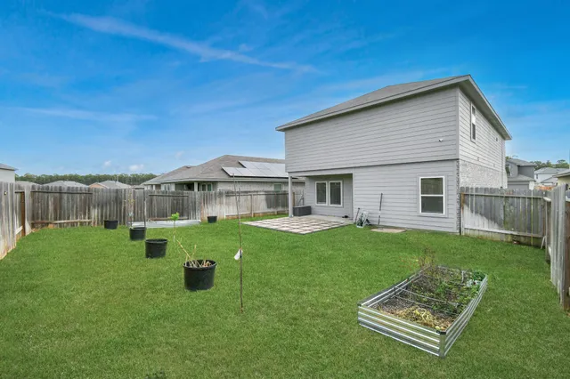 a view of a house with a backyard