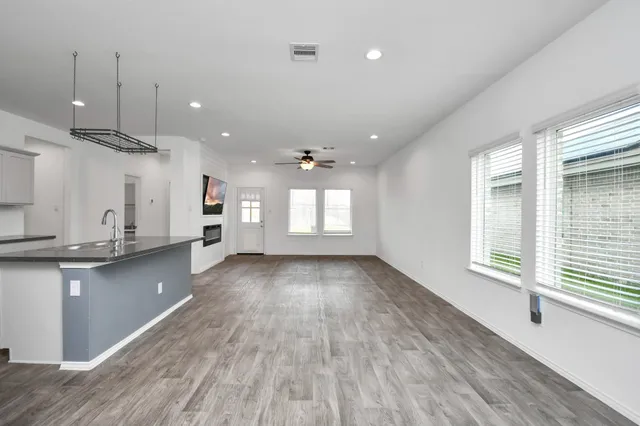 a view of kitchen and kitchen with sink wooden floor