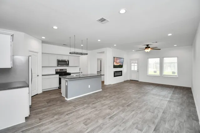 a large kitchen with cabinets and stainless steel appliances