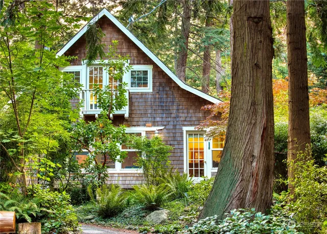 a view of a house with brick walls and potted plants