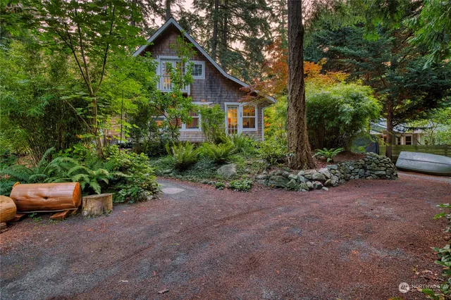 a view of a house with a yard and sitting area