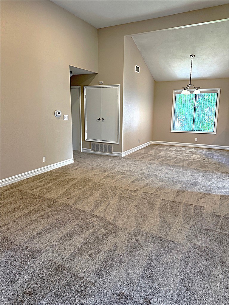 545 South Ranch View Circle, Unit 97 Anaheim Hills, CA 92807 - Photo 11 of 33 an empty room with window and wooden floor