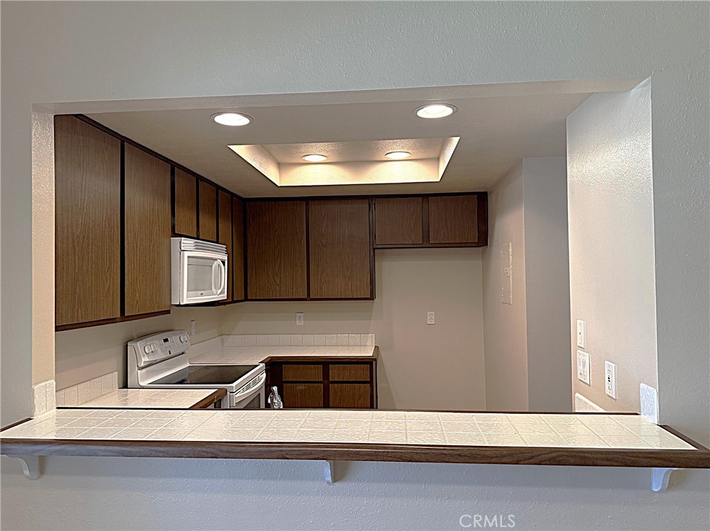 545 South Ranch View Circle, Unit 97 Anaheim Hills, CA 92807 - Photo 14 of 33 a kitchen with a sink and a refrigerator