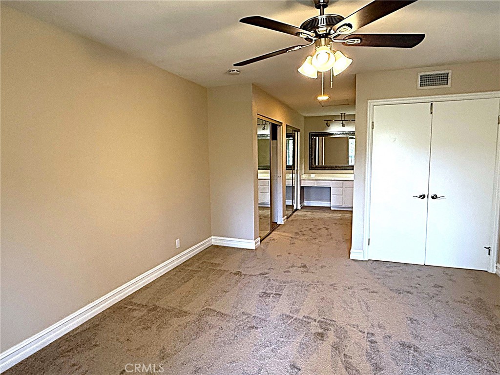 545 South Ranch View Circle, Unit 97 Anaheim Hills, CA 92807 - Photo 3 of 33 a view of a livingroom with a chandelier furniture and a ceiling fan