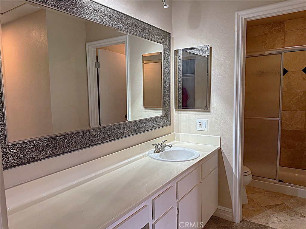 545 South Ranch View Circle, Unit 97 Anaheim Hills, CA 92807 - Photo 9 of 33 a bathroom with a sink and a mirror