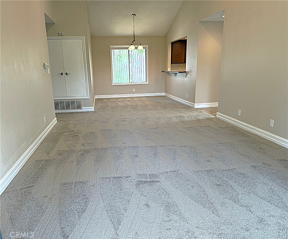 545 South Ranch View Circle, Unit 97 Anaheim Hills, CA 92807 - Photo 10 of 33 an empty room with windows and chandelier fan