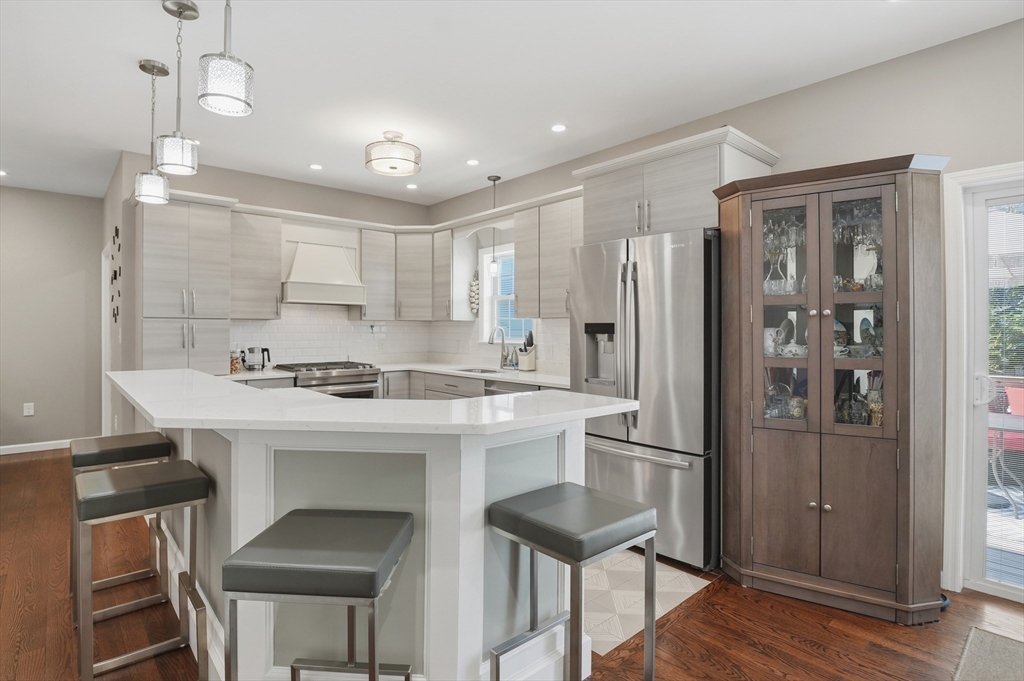 112 Pineland Avenue Worcester, MA 01604 - Photo 10 of 38 a kitchen with kitchen island a sink stove and refrigerator