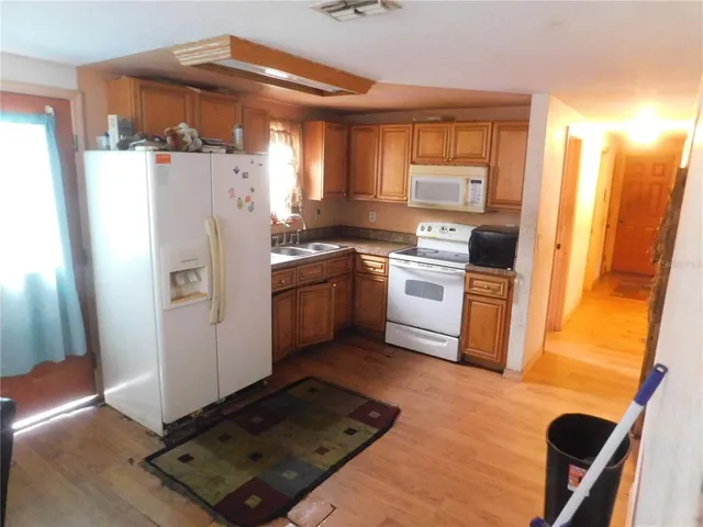 a kitchen with stainless steel appliances a refrigerator sink and cabinets
