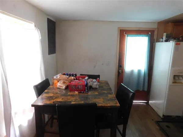 a view of a dining room with furniture and window