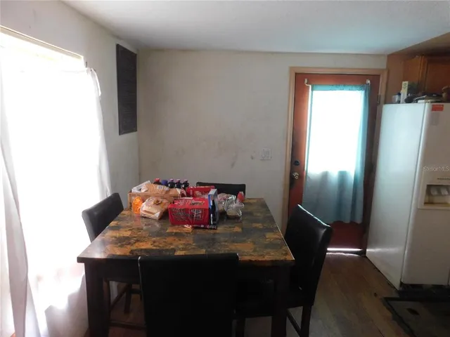a view of a dining room with furniture and window