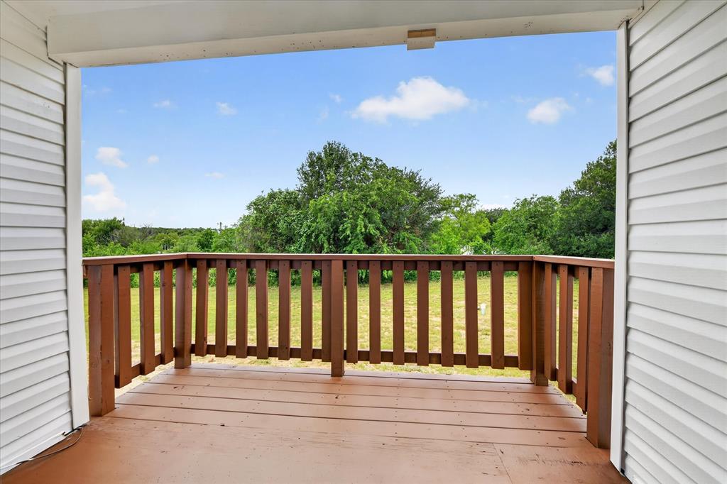 134 Classic Country Court Springtown, TX 76082 - Photo 29 of 35 Covered outdoor porch featuring wood-finish flooring and a wood railing