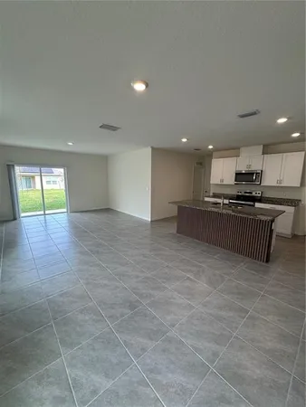 a view of a kitchen with a sink and cabinets