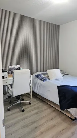 a bedroom with a bed and a table in it