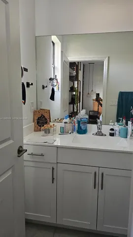 a sink with white cabinets