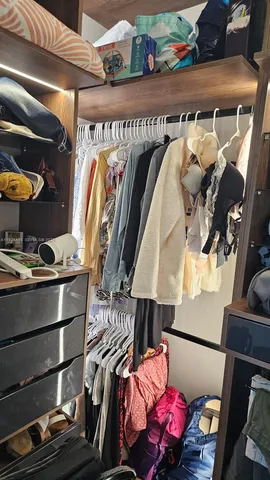 a view of walk in closet with clothes and shoes