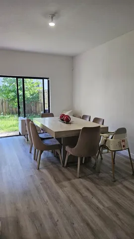 a dining room with furniture and window
