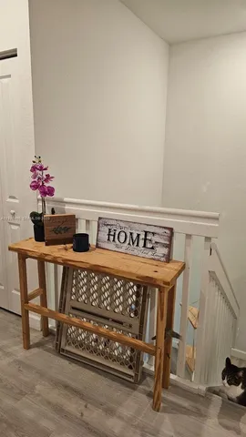 a view of a room with furniture and wooden floor