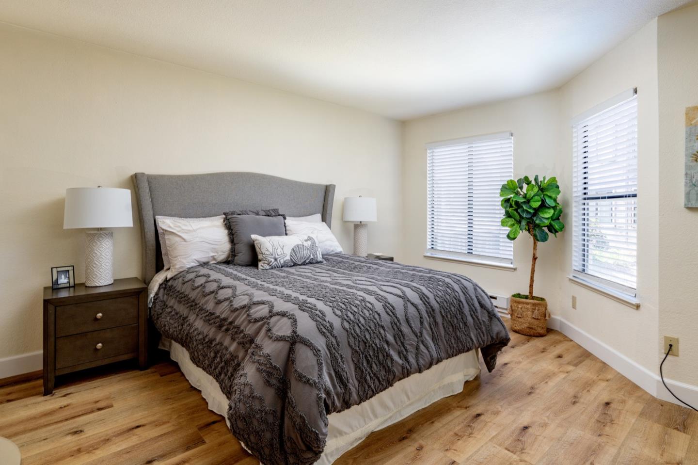 1 Surf Way, Unit 125 Monterey, CA 93940 - Photo 15 of 36 a bedroom with a bed and a potted plant