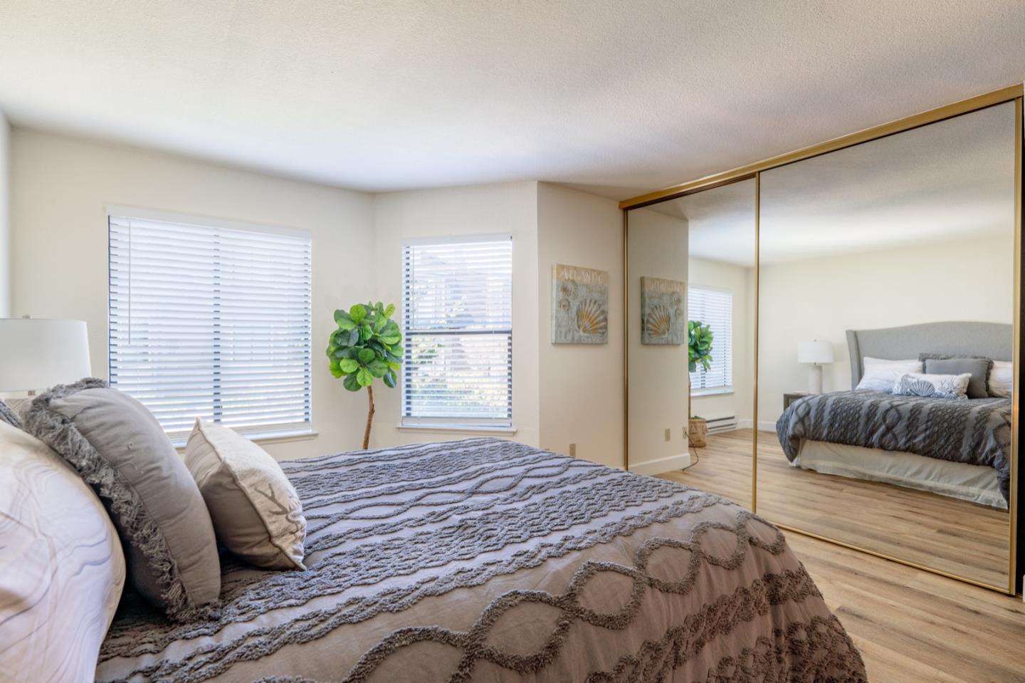 1 Surf Way, Unit 125 Monterey, CA 93940 - Photo 16 of 36 a bedroom with a large bed and a couch