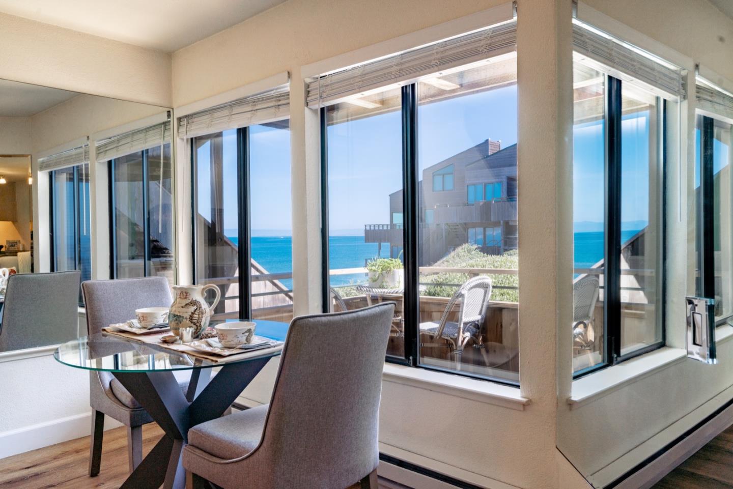 1 Surf Way, Unit 125 Monterey, CA 93940 - Photo 4 of 36 a view of a dining room with furniture window and wooden floor
