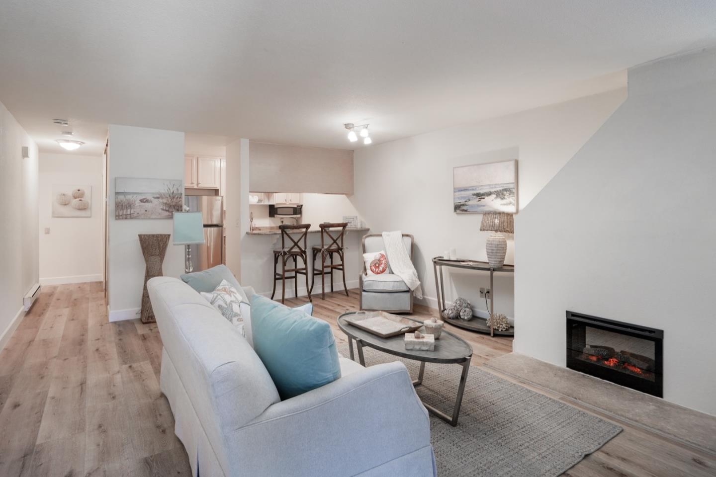 1 Surf Way, Unit 125 Monterey, CA 93940 - Photo 7 of 36 a living room with furniture and a fireplace