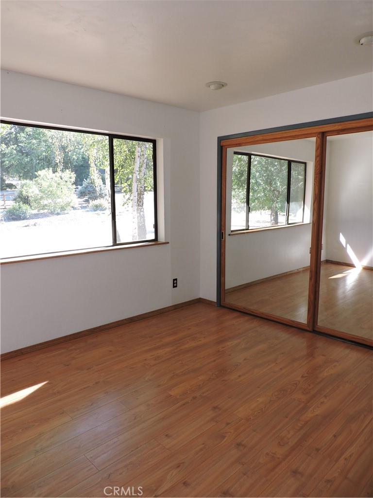 26931 Columbia Way Tehachapi, CA 93561 - Photo 41 of 49 Guest Bedroom has amazing mountain views! New interior paint, hardwood flooring and large closet with mirrored doors.