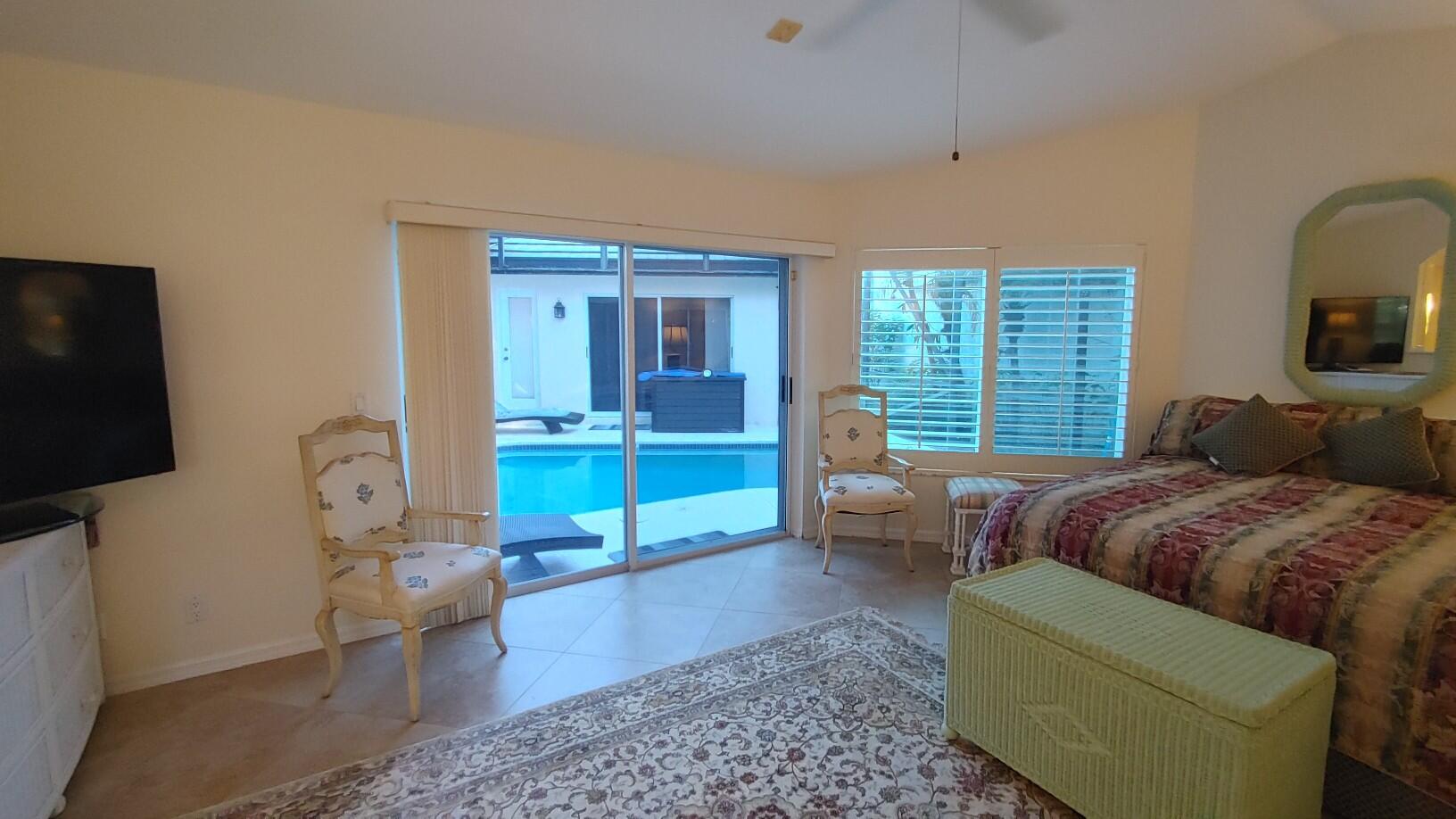 16461 Riverwind Drive Jupiter, FL 33477 - Photo 20 of 45 a living room with furniture and a flat screen tv