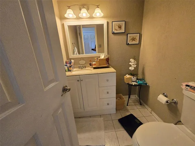 a bathroom with a sink a toilet and mirror