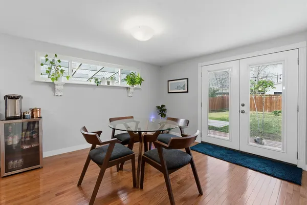 a view of a dining room with furniture window and wooden floor