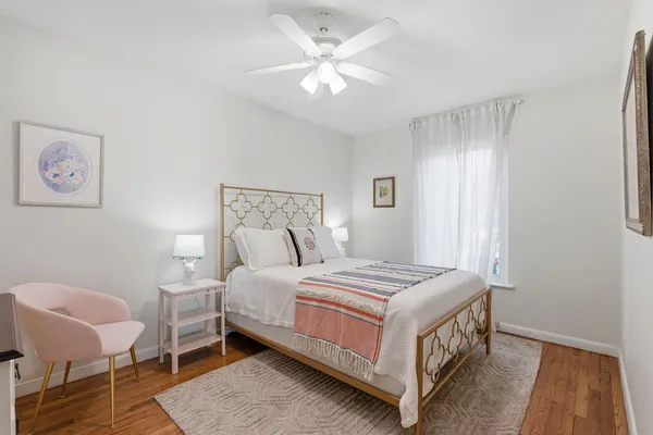 a bedroom with a bed and a chair