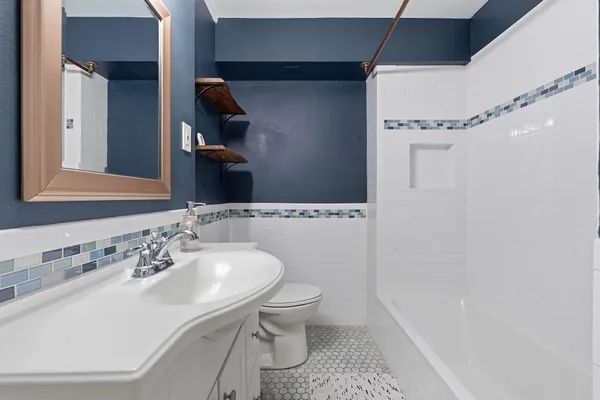 a bathroom with a sink toilet and shower