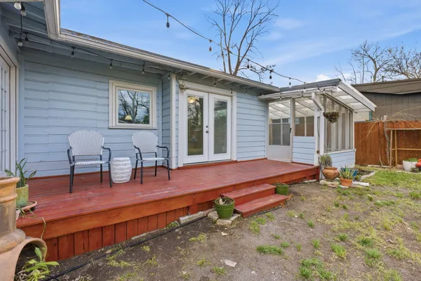a backyard of a house with barbeque oven table and chairs