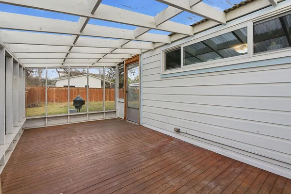 a view of a room with wooden floor