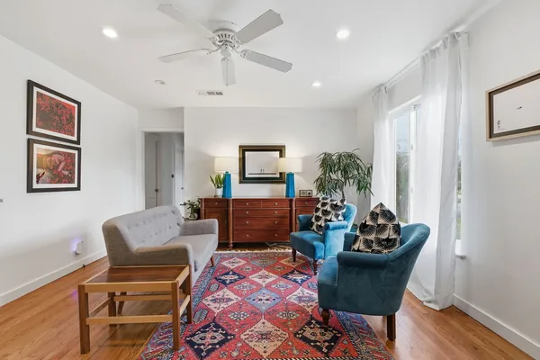 a living room with furniture and a potted plant