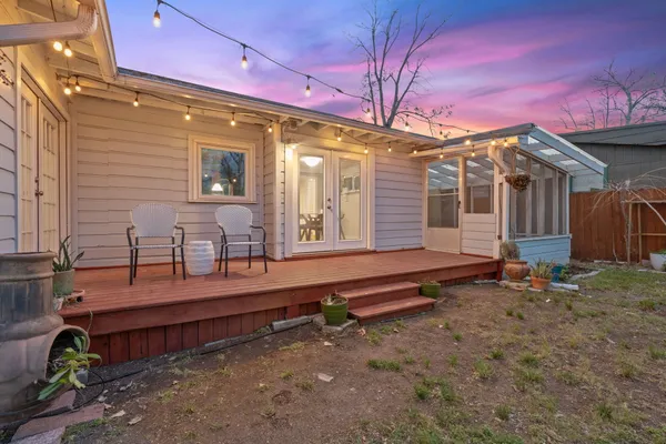a backyard of a house with barbeque oven table and chairs